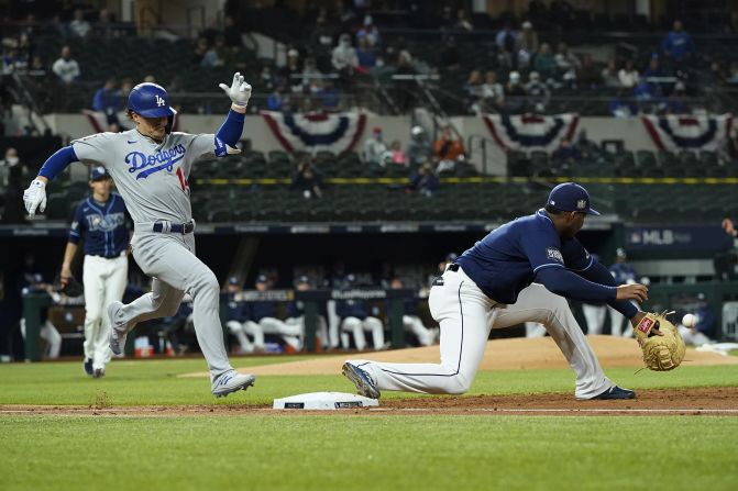 The Dodgers' Enrique Hernandez is forced out at first by the Rays' first baseman Yandy Diaz during the third inning. 