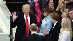 WASHINGTON, DC - JANUARY 20:  Supreme Court Justice John Roberts (2L) administers the oath of office to U.S. President Donald Trump (L) as his wife Melania Trump holds the Bible on the West Front of the U.S. Capitol on January 20, 2017 in Washington, DC. In today's inauguration ceremony Donald J. Trump becomes the 45th president of the United States.  (Photo by Drew Angerer/Getty Images)
