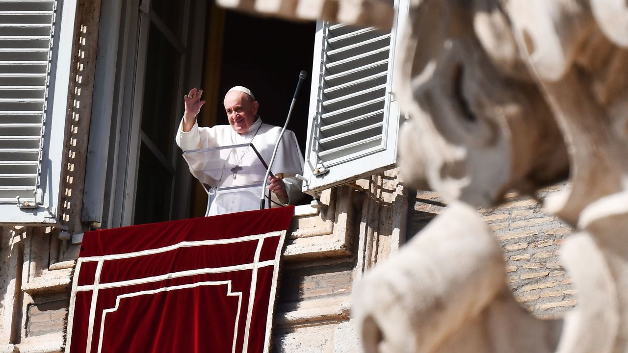 Pope Francis waves to pilgrims gathered in St. Peter's square during his Sunday Angelus prayer on October 25, 2020, at the Vatican.