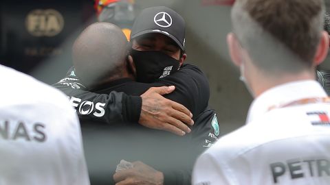 Hamilton celebrates his victory with his father Anthony.