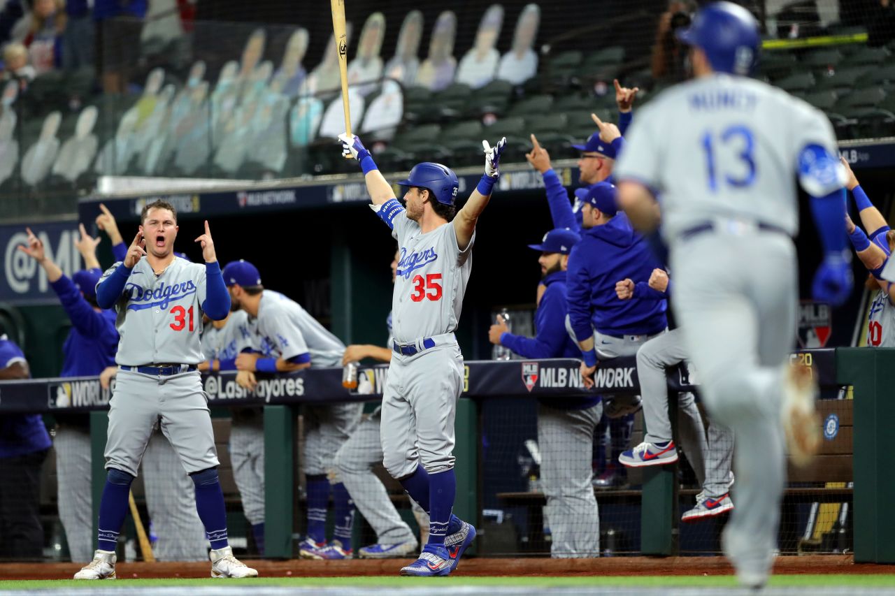 Joc Pederson and Cody Bellinger of the Los Angeles Dodgers react to a Max Muncy solo home run in the fifth inning during Game 5 of the World Series at Globe Life Field on Sunday, October 25, in Arlington, Texas.