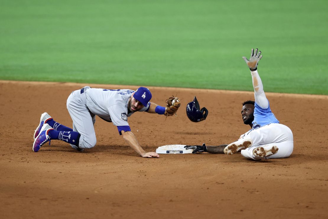Chris Taylor #3 of the Los Angeles Dodgers tags out Randy Arozarena #56 of the Tampa Bay Rays stolen base attempt during the third innings in Game Five of the 2020 MLB World Series at Globe Life Field on October 25, 2020 in Arlington, Texas.