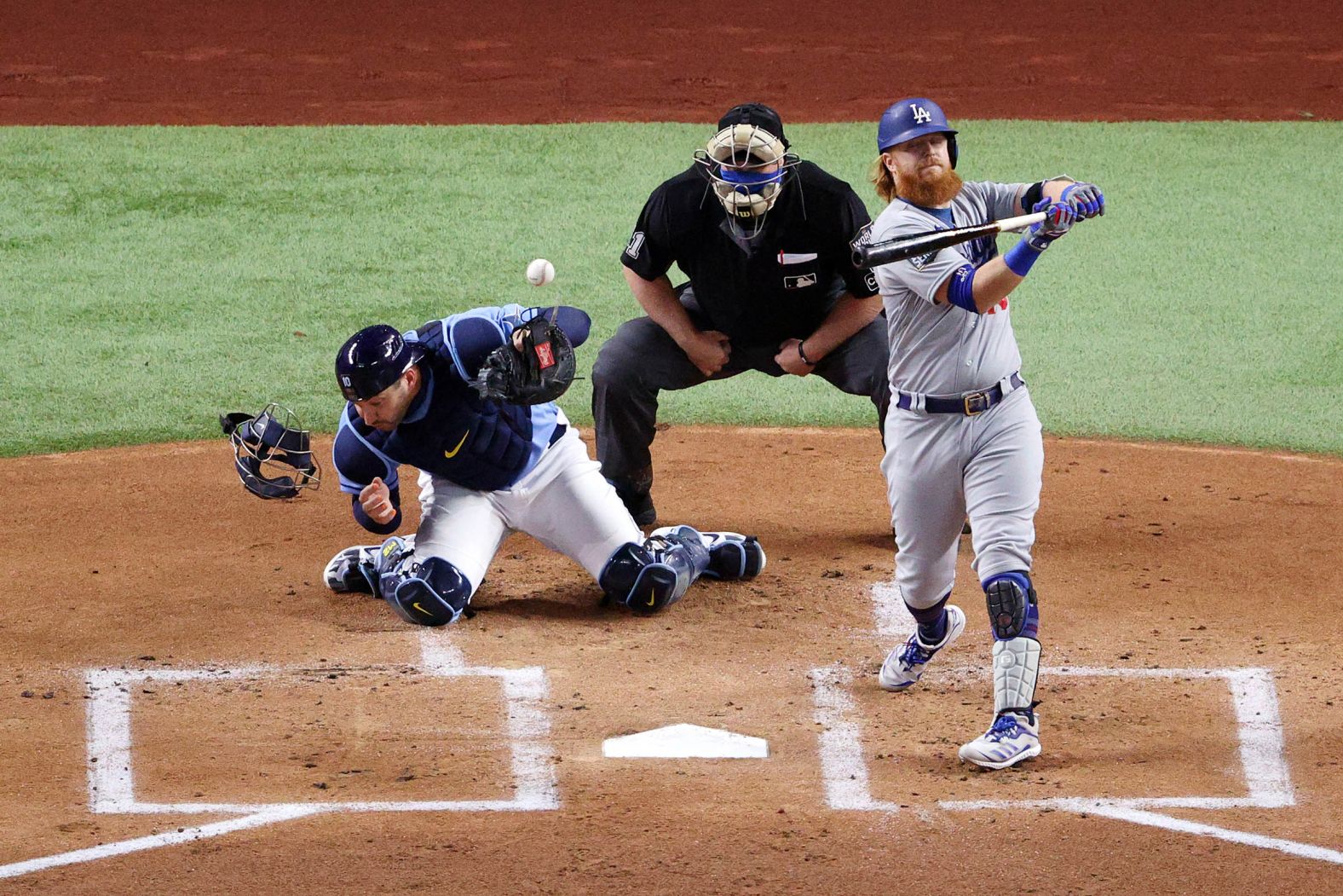 Rays catcher Mike Zunino is unable to field a wild pitch with Justin Turner of the Dodgers at the plate during the first inning. 