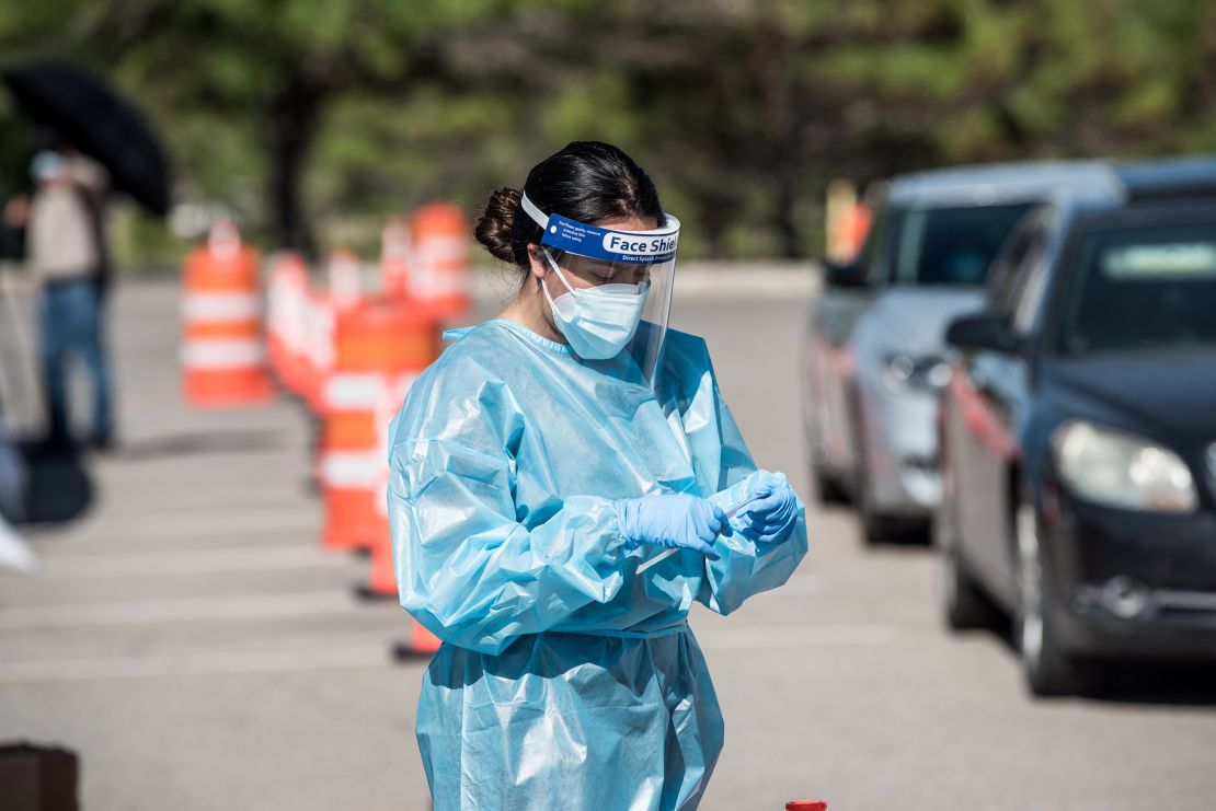A nurse pulls out a testing swab at a newly opened mega drive-thru site at El Paso Community College Valle Verde campus on July 21, 2020 in El Paso, Texas. 