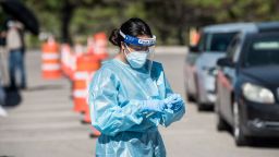 A nurse pulls out a testing swab at a newly opened mega Covid-19 drive-thru site in El Paso.