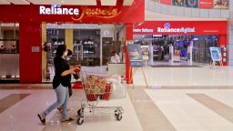 A customer wearing protective mask pushes a trolley with grocery items past Reliance Jewels and Reliance Digital stores of Reliance Industries Ltd, in Mumbai, India, October 7, 2020. Niharika Kulkarni/Reuters
