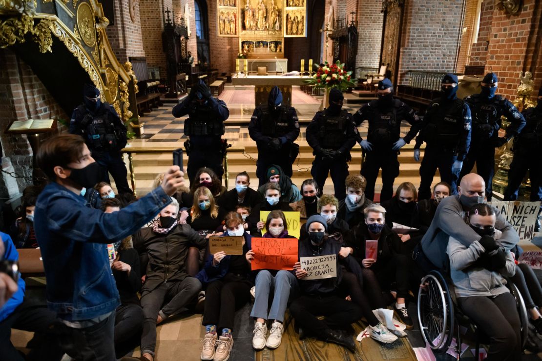 Demonstrators protest against the tightening of the abortion law at the Archcathedral Basilica of St. Peter and St. Paul in Poznan, Poland, Sunday.