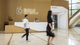 People walk past the reception desk at the Ant Group Co. headquarters in Hangzhou, China, on Monday, Sept. 28, 2020. Jack Ma's Ant Group is seeking to raise $17.5 billion in its Hong Kong share sale and won't seek to lock in cornerstone investors, confident there will be plenty of demand for one of the largest equity deals in the financial hub, according to people familiar with the matter. Photographer: Qilai Shen/Bloomberg via Getty Images