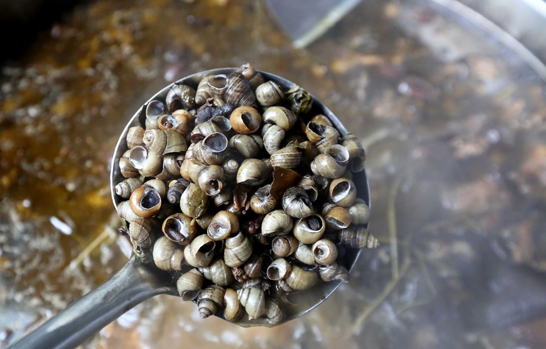 Chinese workers produce soup for packaged luosifen at a factory in Liuzhou city. 