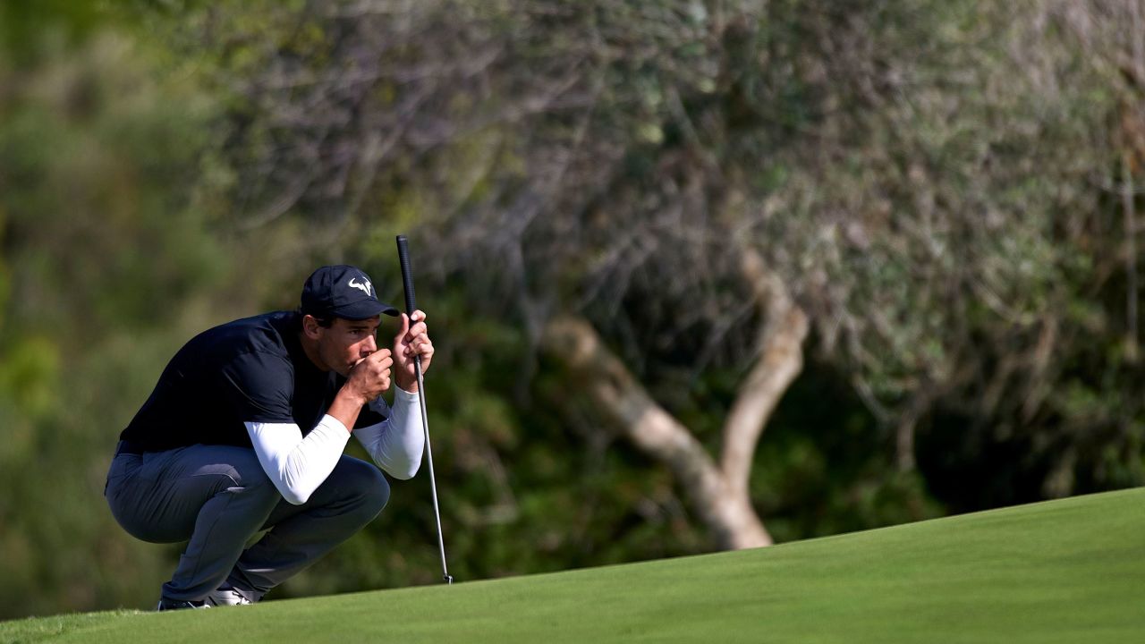 Nadal lines up a putt.