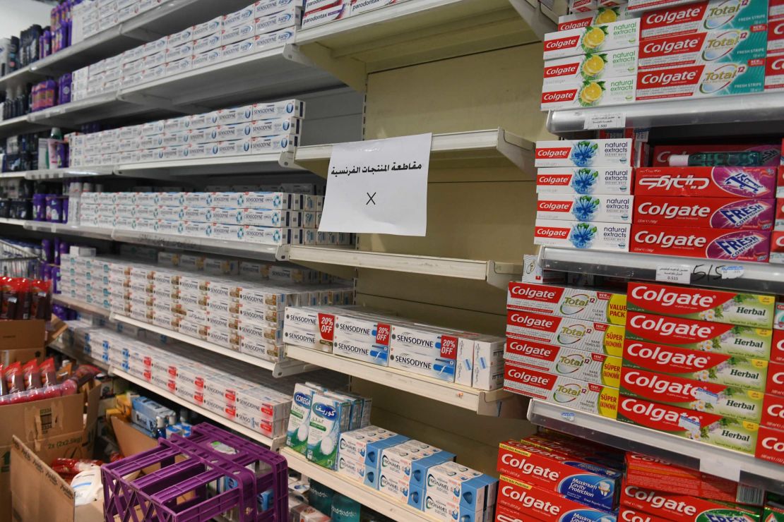 A sign is placed on partially empty shelves at a market, boycotting French goods in Kuwait City, Kuwait on October 24