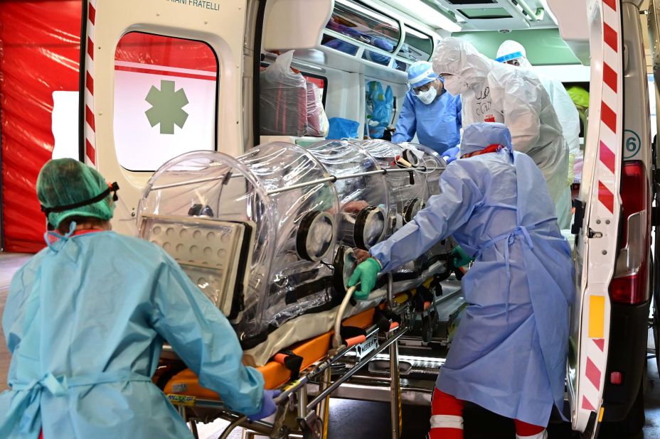 Medical staff use a biocontainment stretcher to transfer a Covid-19 patient to a hospital in Varese, Italy, on October 19.