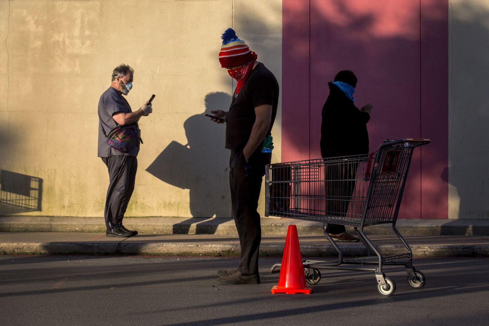 Customers stand outside an H.E.B. grocery store in Austin, Texas, in April.