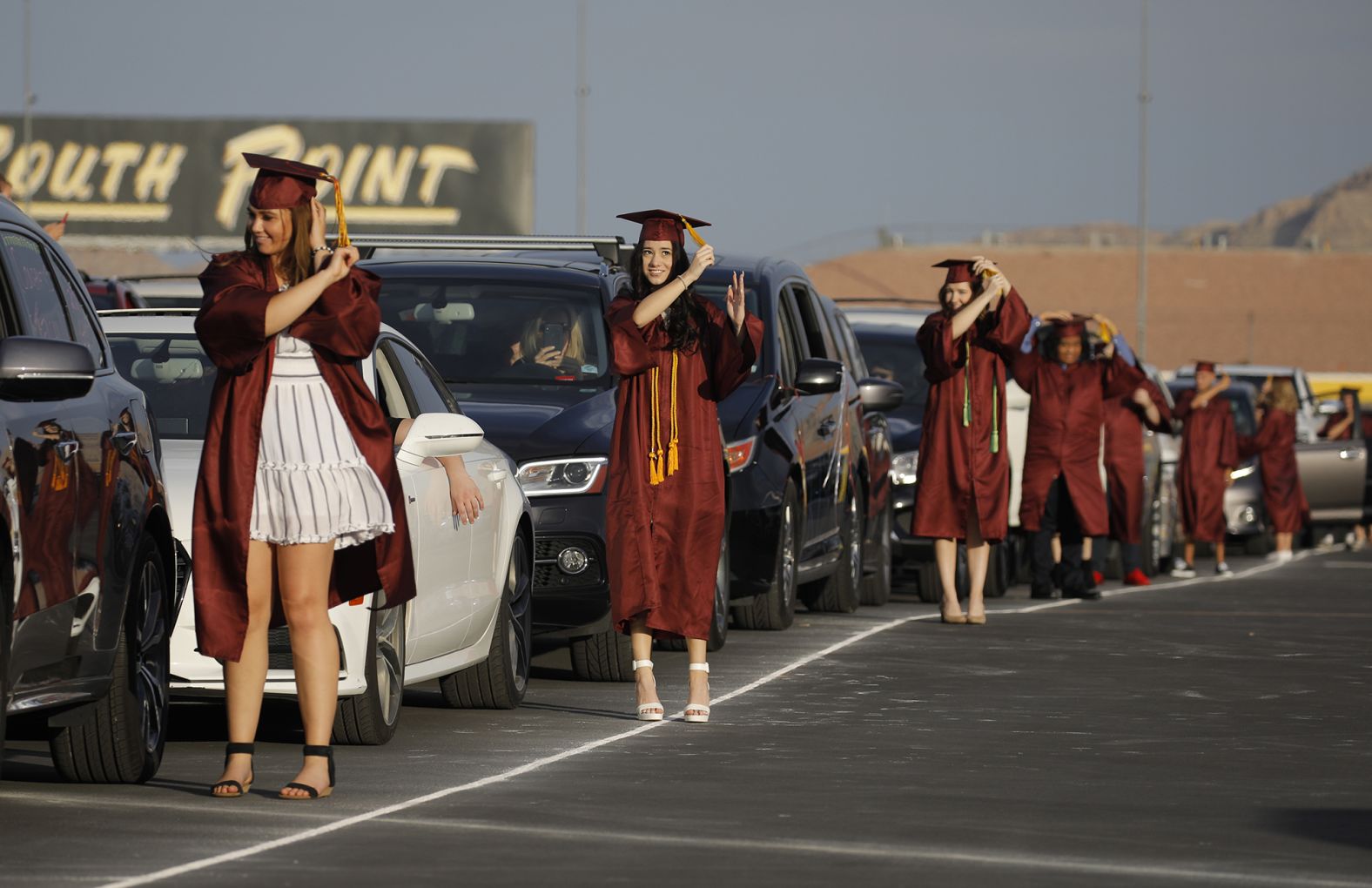 High school graduates turn their tassels during a drive-thru graduation ceremony at the Las Vegas Motor Speedway in May.