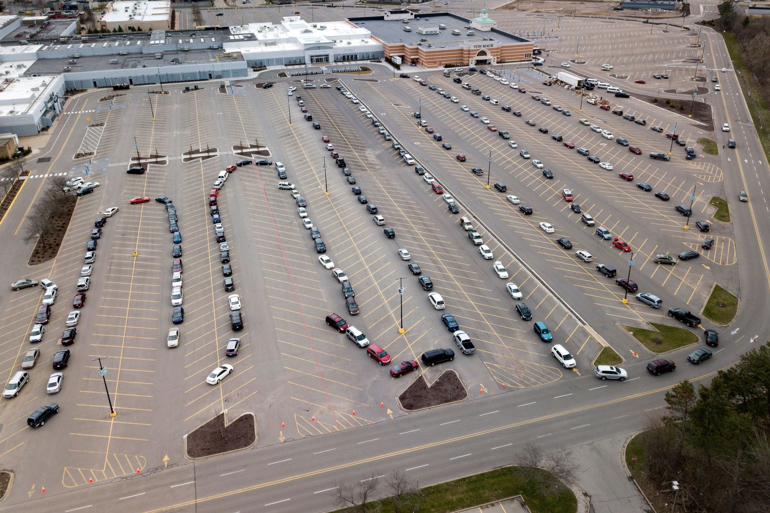 Cars line up in a mall parking lot for a drive-thru food pantry in Grand Rapids, Michigan, in April.