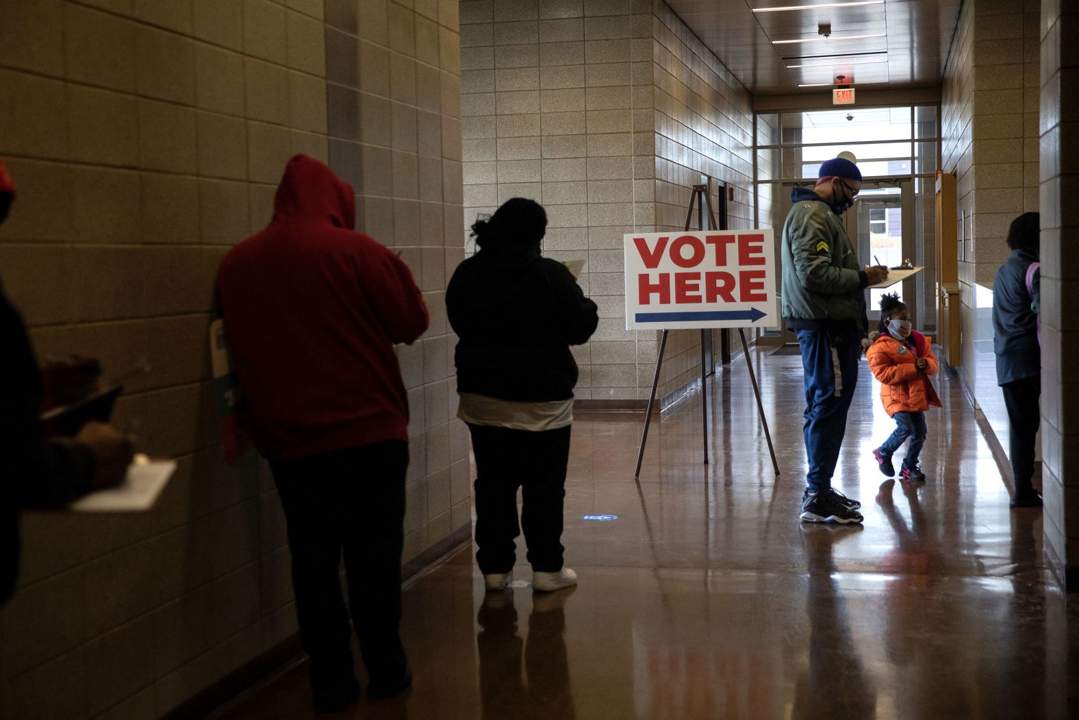 People stand in line to cast their ballots in Detroit on October 24.