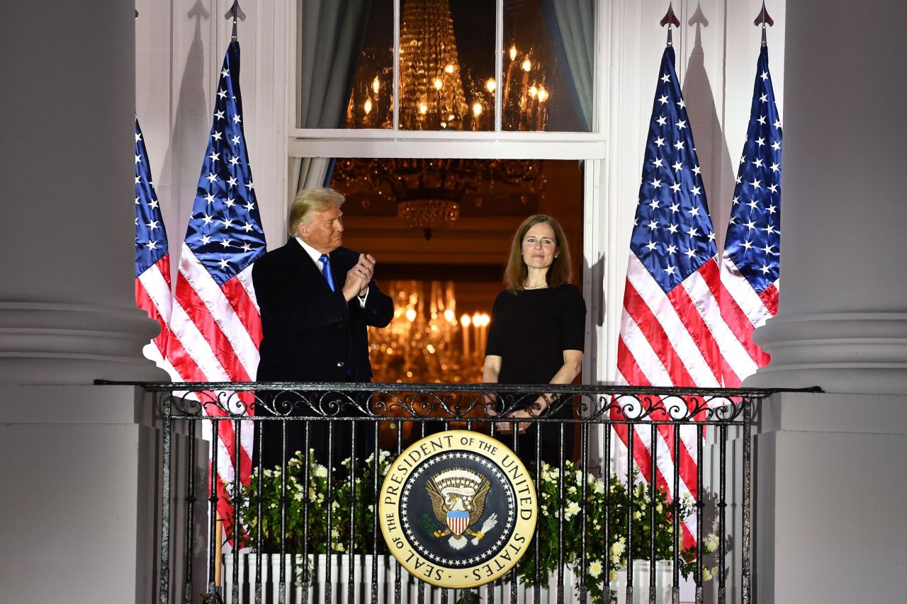 President Donald Trump applauds Barrett after she was sworn in on October 26.