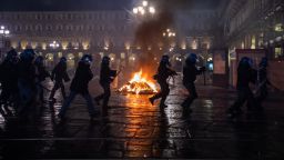 Demonstrators clash with Riot Police during the protest against the lockdown in Piazza Castello on October 26, 2020 in Turin, Italy. The protest is organized  to protest against the blockade to restaurant and bars and curfew imposed in the Piedmont Region and by the Italian Government of the evening lockdown which will start from today at 6pm to contain the coronavirus pandemic. (Photo by Mauro Ujetto/NurPhoto via Getty Images)