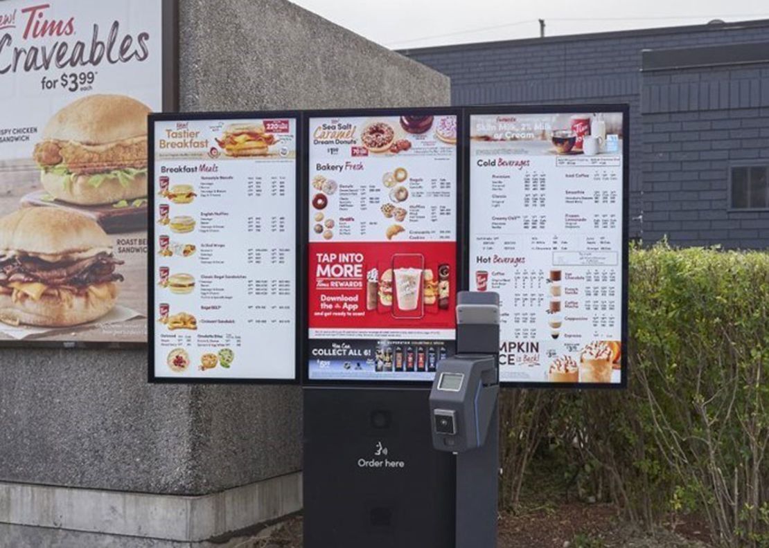 A Tim Hortons digital menu boards with loyalty program integration and  contactless payment. 