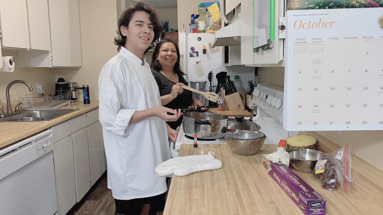 Laura Gonzalez (right) of Seattle, and Marcos, her 13-year-old son (left), cook special weekend meals. She said he is responsible with his distance learning, but she worries he's home alone while she works.