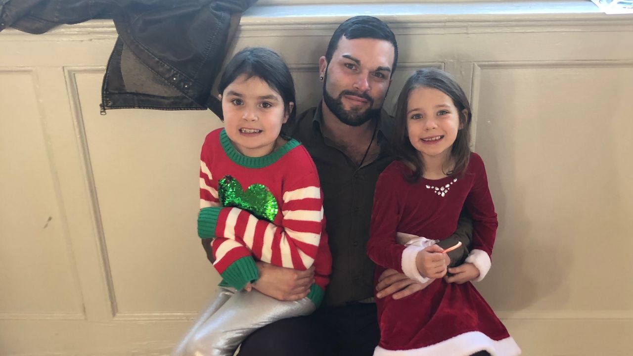 Robert Kent (center) of Warren, Rhode Island, single dad to daughters Ayla (left) and Bella  (right), oversees their online learning three days a week. 