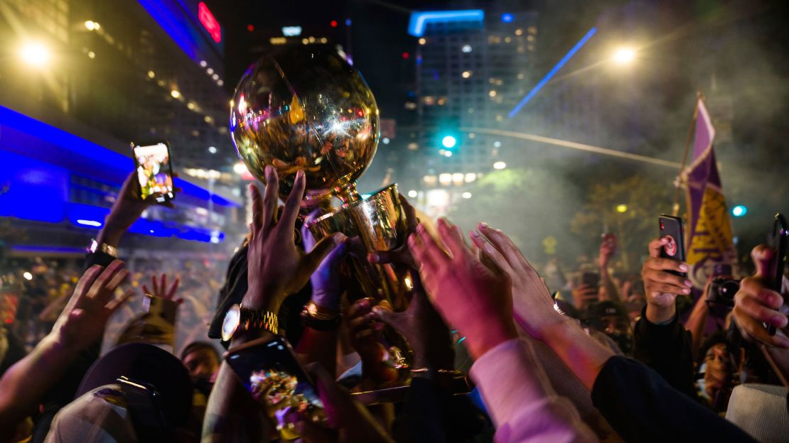 Fans celebrate, Sunday, Oct. 11, 2020, in Los Angeles, after the Los Angeles Lakers defeated the Miami Heat in Game 6 of basketball's NBA Finals to win the championship. (AP Photo/Jintak Han)