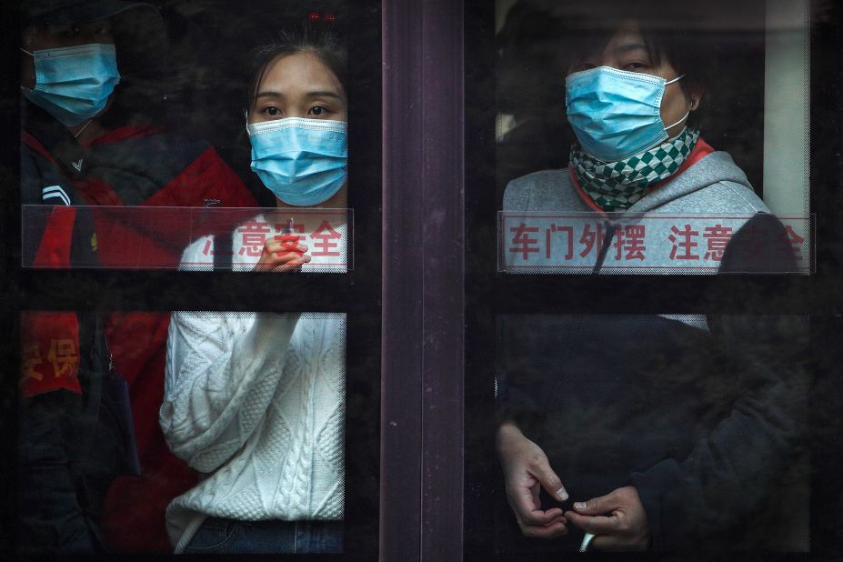 Commuters ride a bus in Beijing during rush hour on October 26.