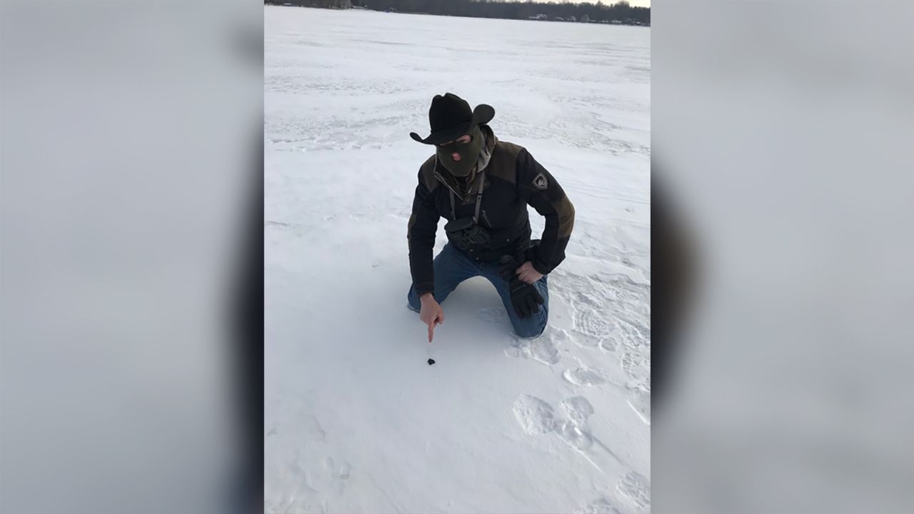 Meteorite hunter Robert Ward is pictured with the meteorite on Strawberry Lake near Hamburg, Michigan.