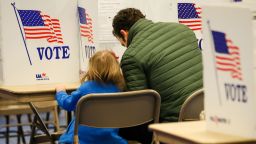 BEDFORD, NH - FEBRUARY 11: Nick Botto casts a ballot at Bedford High School with his 3 year old daughter Violet during the New Hampshire primary on February 11, 2020 in Bedford, New Hampshire. (Photo by Matthew Cavanaugh/Getty Images)