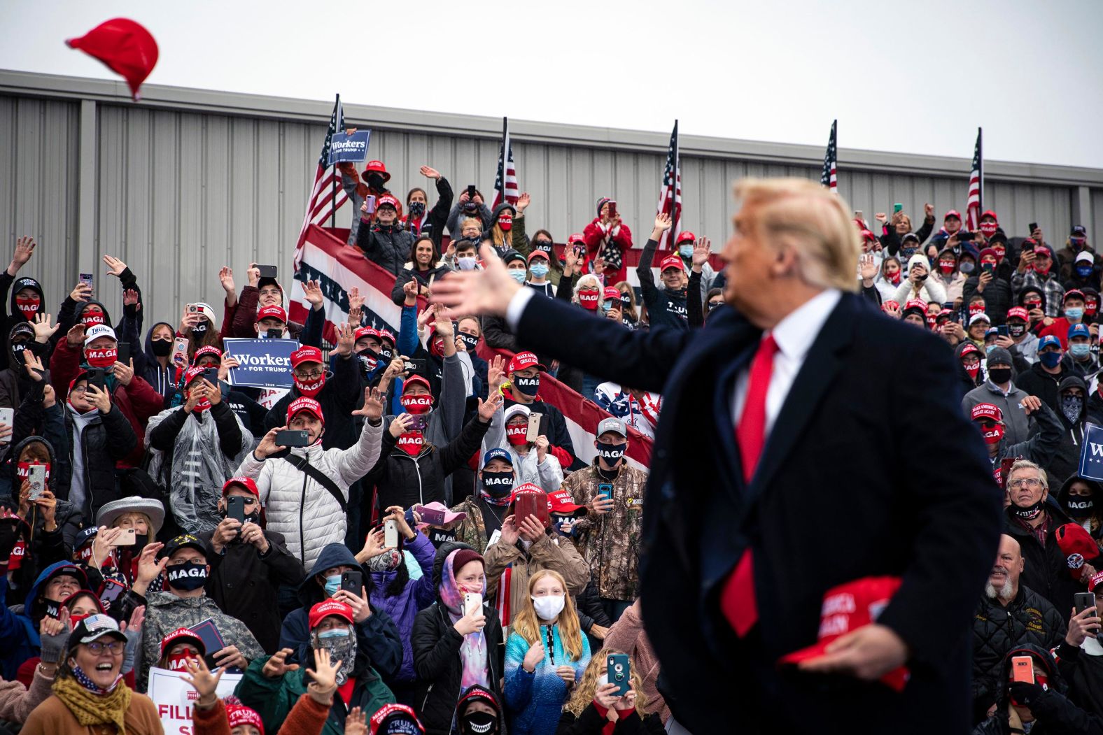 Trump tosses hats into the crowd at a campaign rally in Allentown, Pennsylvania, on October 26.