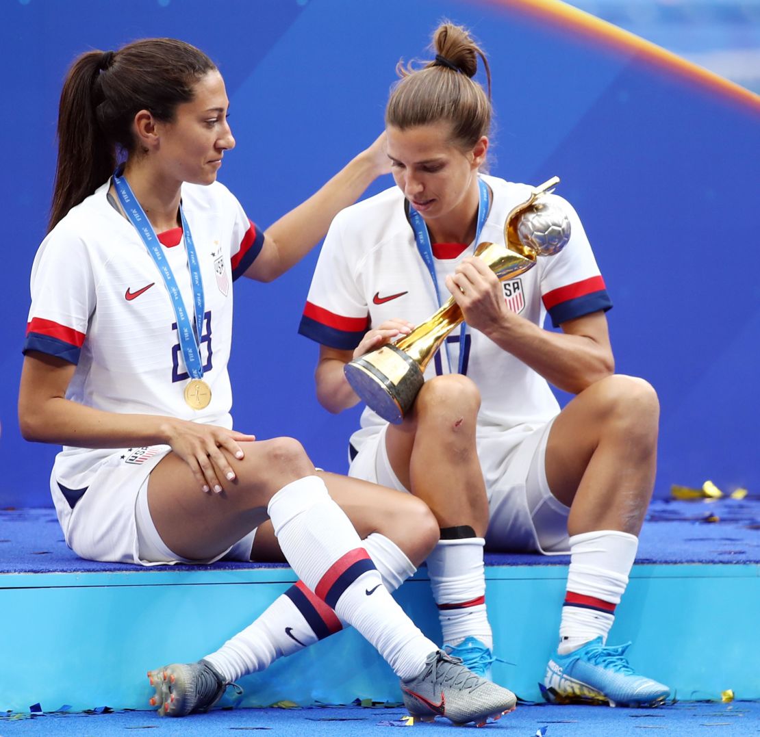 Tobin Heath and Christen Press celebrate with the FIFA Women's World Cup trophy.