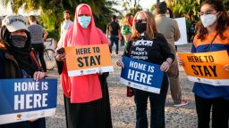 People hold signs during a rally in support of the Supreme Court's ruling in favor of the Deferred Action for Childhood Arrivals (DACA) program, in San Diego, California June 18, 2020. - Supreme Court dealt President Donald Trump's anti-immigration  efforts a fresh blow Thursday when it rejected his cancellation of a program protecting 700,000 "Dreamers," undocumented migrants brought to the United States as children. (Photo by Sandy Huffaker / AFP) (Photo by SANDY HUFFAKER/AFP via Getty Images)