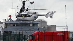 A French rescue helicopter lands close to a rescue vessel in Dunkirk, northern France, Tuesday, Oct. 27, 2020 during a  search operation after four migrants' boat capsized while they and other migrants tried to cross the English Channel to Britain, French authorities said. 