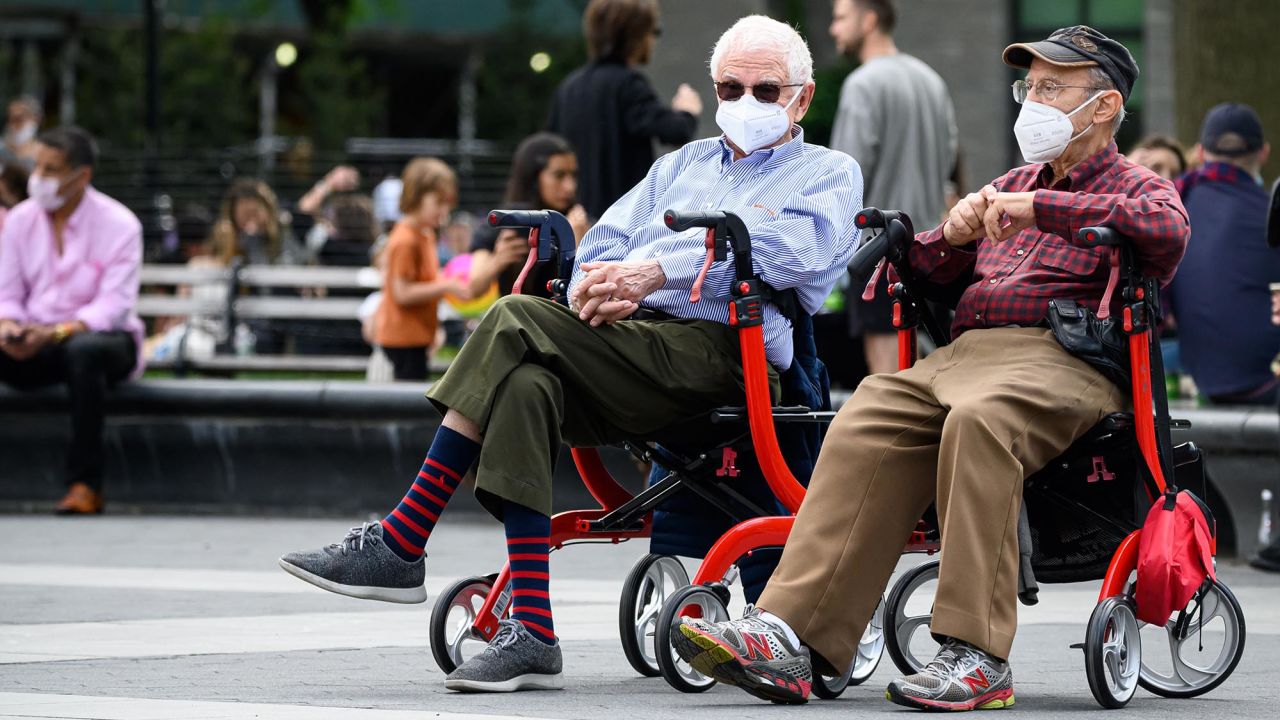 People wear protective face masks in Washington Square Park in New York City during the coronavirus pandemic.