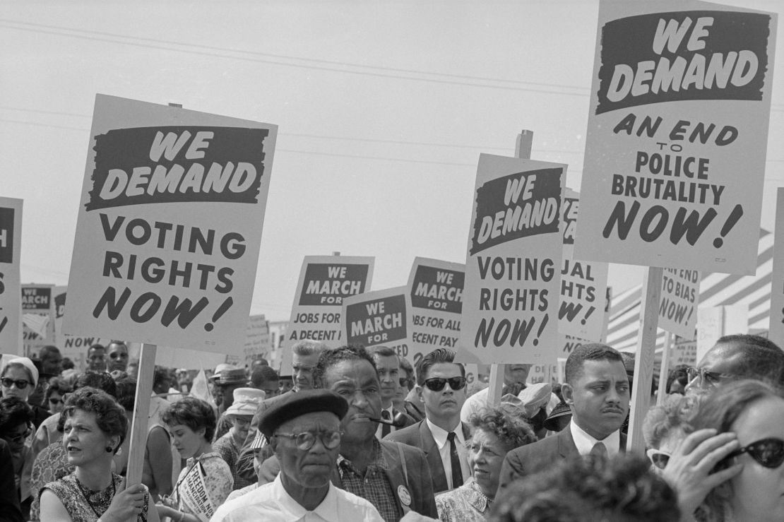 Demonstrators hold up signs calling for voting rights at the March on Washington for Jobs and Freedom on August 28, 1963, in Washington, DC. 