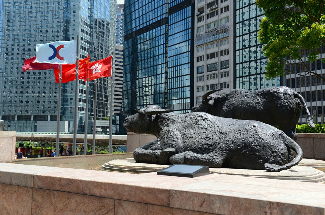 Bull sculptures and flags flying outside Exchange Square, home of the Hong Kong Stock Exchange.