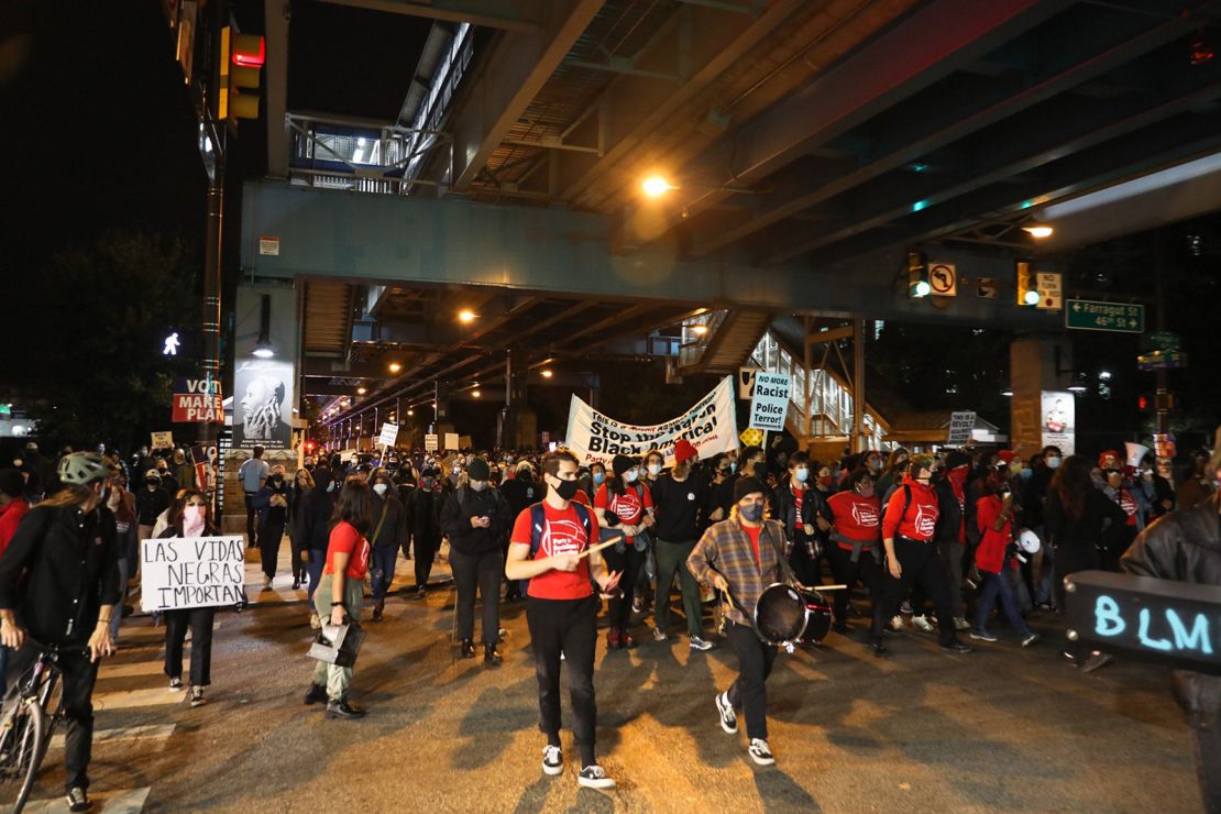 People hold banners and signs during a demonstration Wednesday in Philadelphia.