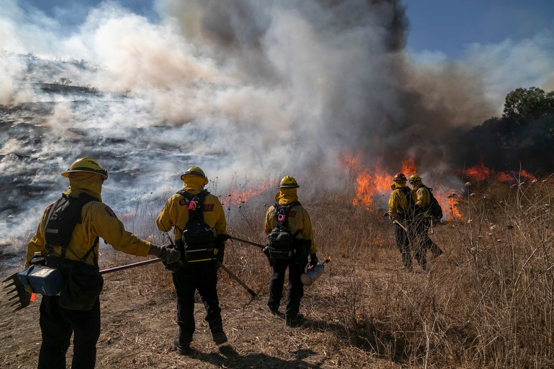 Firefighters set a backfire to protect homes and try to contain the Blue Ridge Fire.