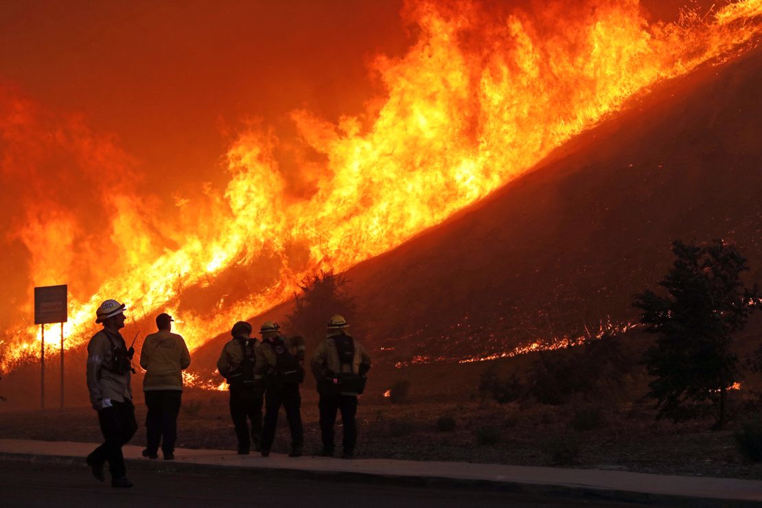 Firefighters conduct a backfire operation on brush at Chino Hills State Park during the Blue Ridge fire.