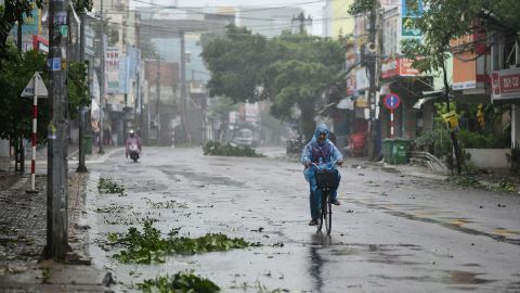A man rides along a deserted road amid strong winds in central Vietnam's Quang Ngai province on October 28, 2020, as Typhoon Molave makes landfall.