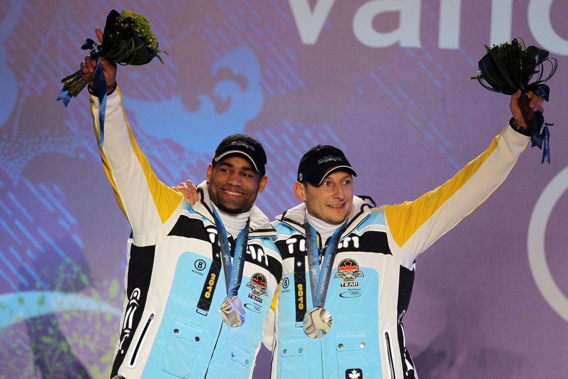 Adjei (left) and Thomas Florschütz receive silver medals in the men's two-man bobsled at the 2010 Winter Olympics. 