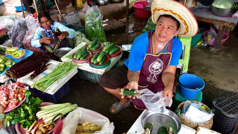 <strong>Market vendor:</strong> Perusing the produce at the market in Phibun Mangsahan. This small city in Ubon Ratchathani province is also known for its giant gongs and steamed buns. 