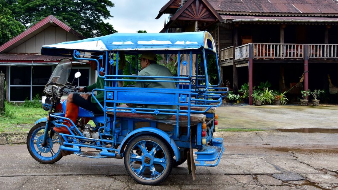 <strong>Sao Homestay: </strong>A passenger catches a ride in an Isaan-style tuk tuk in front of Sao Homestay Tai Yor, which charges 199 baht per night ($6.62), per person, including meals. Focusing entirely on domestic tourists, its motto is "Eat Mekong fish and cruising." 