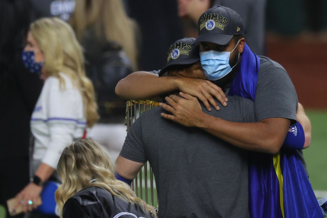 Justin Turner hugs teammate Kenley Jansen after testing positive for coronavirus.