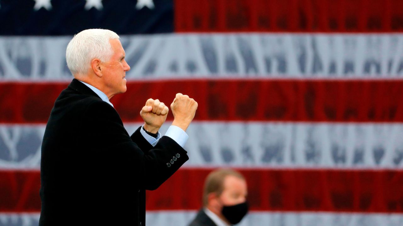 US Vice President Mike Pence walks on stage at a "Make America Great Again!" campaign event at Oakland County International Airport in Waterford, Michigan, on October 22, 2020. 