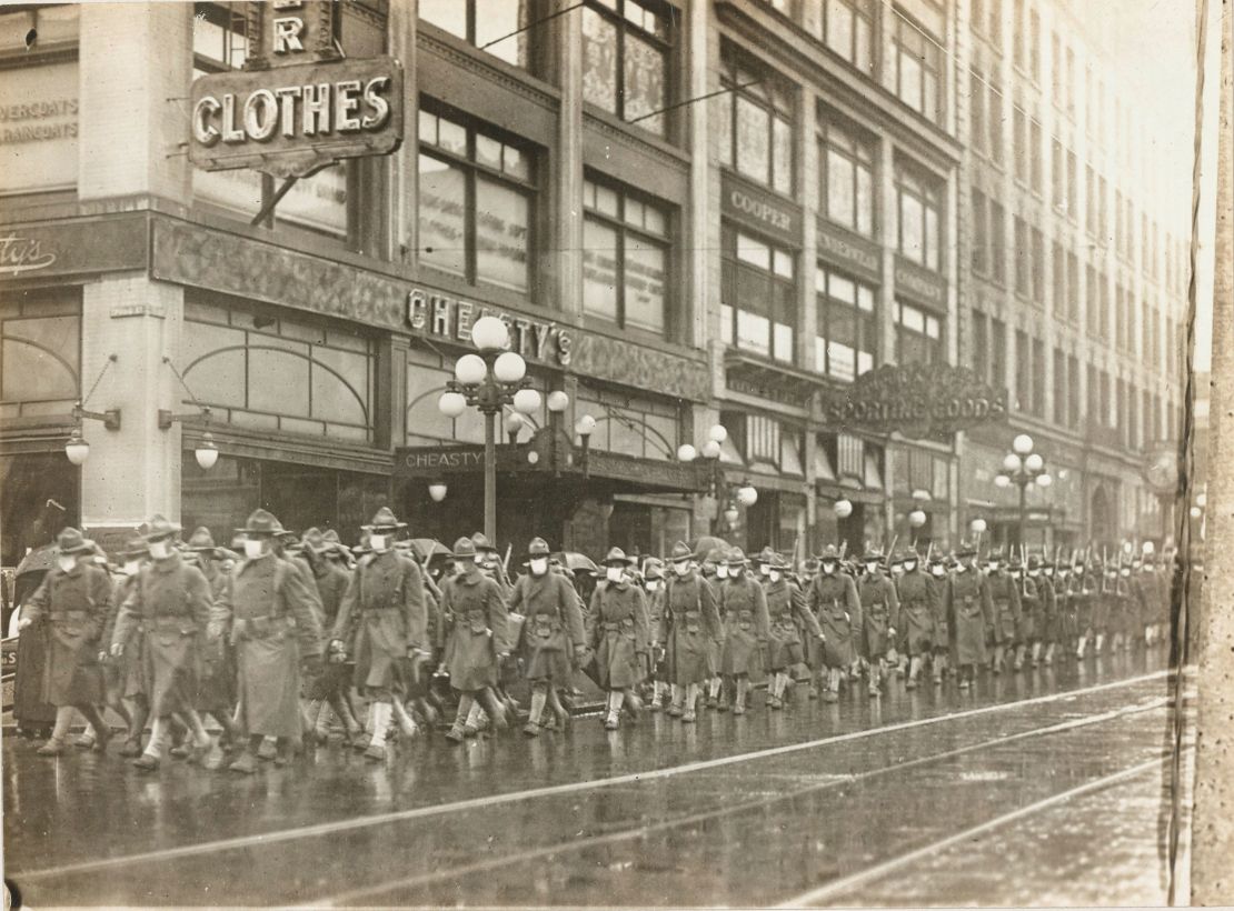 The 39th Regiment marched through the streets of Seattle in December 1918, while wearing masks made by the Seattle Chapter of the Red Cross.