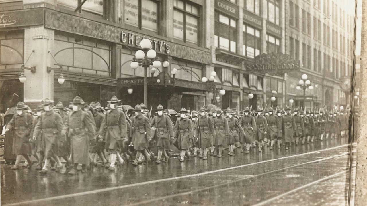 The 39th Regiment marched through the streets of Seattle in December 1918, while wearing masks made by the Seattle Chapter of the Red Cross. 