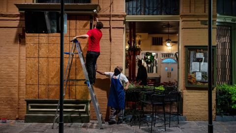General manager Gaige Rodriguez, left, and cook Michael Dillon board up windows at Pere Antoine Restaurant in New Orleans in preparation for Hurricane Zeta, which made landfall Wednesday.