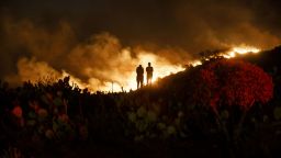 People watch from a hillside during the Silverado Fire in Lake Forest, California, U.S., on Monday, Oct. 26, 2020. California is grappling with yet another weather-driven disaster as a wildfire propelled by hurricane-force gusts rages south of Los Angeles, with dangerous conditions expected to persist across the precariously-dry state. Photographer: Patrick T. Fallon/Bloomberg via Getty Images