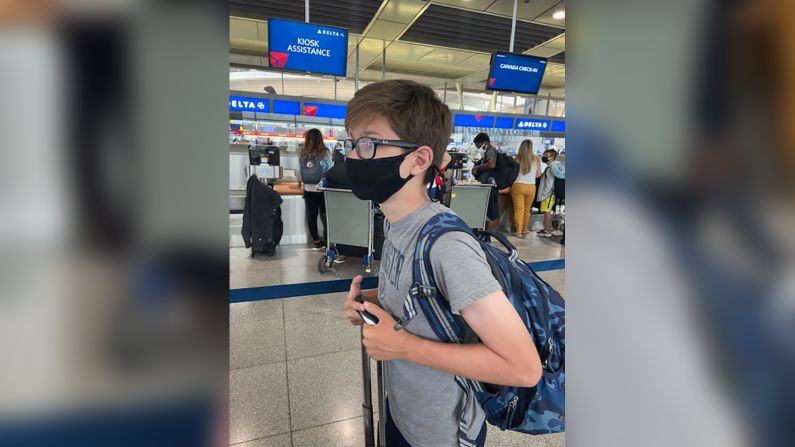 <strong>Up and away: </strong>Jack, 13, put on his mask before arriving at New York's JFK airport.